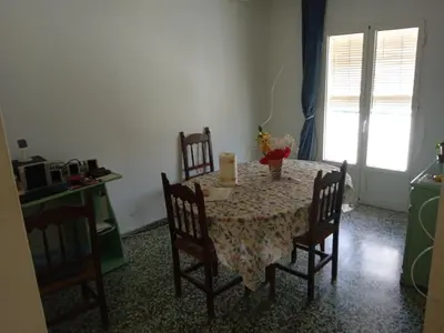 a dining room with a table and chairs and a window at Casa luis puerto in El Puerto de Santa María