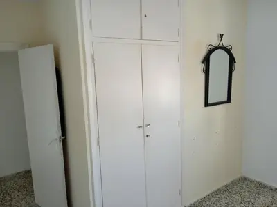 a white closet with a mirror on the wall at Casa luis puerto in El Puerto de Santa María