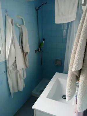 a bathroom with a sink and a shower with towels at Casa luis puerto in El Puerto de Santa María