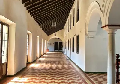 an empty hallway in an old building with a hallway at Apartamento Centro Cabildo Antiguo Convento in Sanlúcar de Barrameda