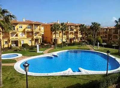 a large swimming pool in front of some apartments at BAJO EN COSTA GADIR in Chiclana de la Frontera