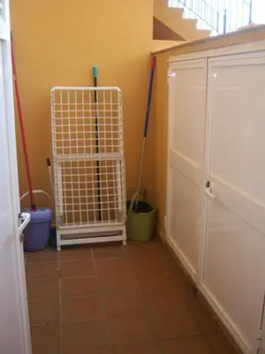 a room with two mops and a tile floor at BAJO EN COSTA GADIR in Chiclana de la Frontera