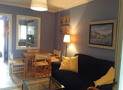 a living room with a couch and a table at BAJO EN COSTA GADIR in Chiclana de la Frontera