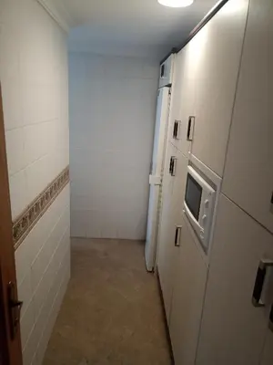 a room with a hallway with a door and a refrigerator at Apartamento Bajo en Valdelagrana, Primera Línea de Playa in El Puerto de Santa María