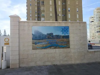 a sign on a wall in front of some buildings at Apartamento Bajo en Valdelagrana, Primera Línea de Playa in El Puerto de Santa María