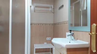 a bathroom with a sink and a mirror at Sherryflat Claveles - Parking in Jerez de la Frontera