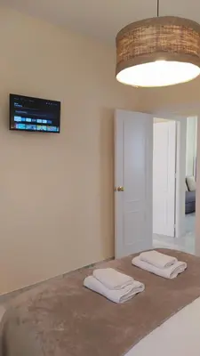 a room with two white towels sitting on a table at Sherryflat Fontana in Jerez de la Frontera