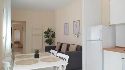 a kitchen and living room with a table and a couch at Sherryflat Fontana in Jerez de la Frontera