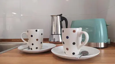 two cups sitting on a counter next to a tea pot at Sherryflat Fontana in Jerez de la Frontera