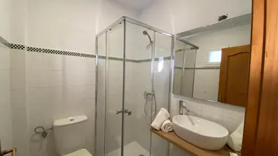 a bathroom with a shower and a toilet and a sink at Alojamiento Rural Al´Mare in Conil de la Frontera