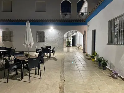 a dining room with tables and chairs in a building at Alojamiento Rural Al´Mare in Conil de la Frontera