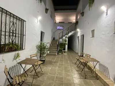 a hallway with tables and chairs in a building at Alojamiento Rural Al´Mare in Conil de la Frontera