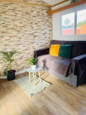a living room with a couch and a table at Alquiler de casa Vacacional in Chiclana de la Frontera