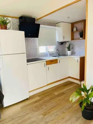 a kitchen with white cabinets and a white refrigerator at Alquiler de casa Vacacional in Chiclana de la Frontera