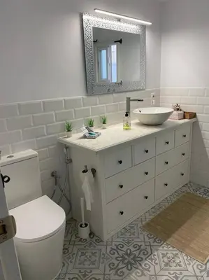 a bathroom with a sink and a toilet and a mirror at Casa im andalusischen Look in der Nähe von Chipiona in Costa Ballena