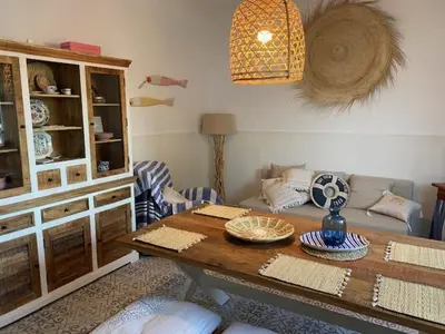 a living room with a table and a couch at Casa im andalusischen Look in der Nähe von Chipiona in Costa Ballena