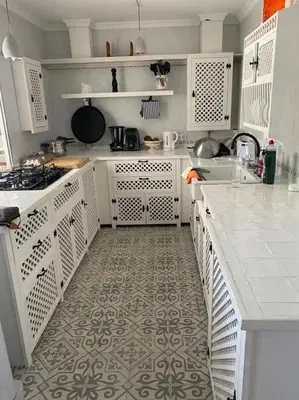 a kitchen with white cabinets and a tile floor at Casa im andalusischen Look in der Nähe von Chipiona in Costa Ballena
