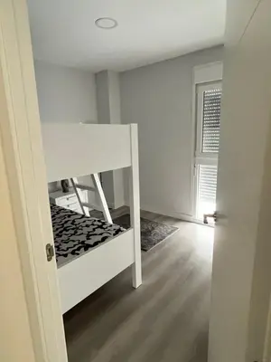 a bedroom with a bunk bed and a window at Piso Palacios in El Puerto de Santa María